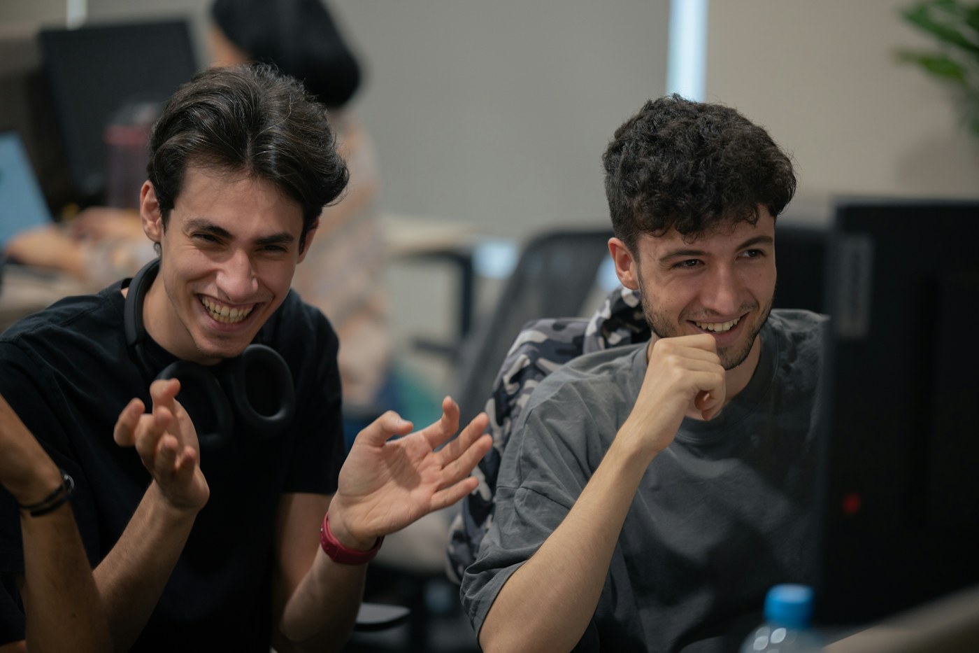 Two software developers discussing work at a computer